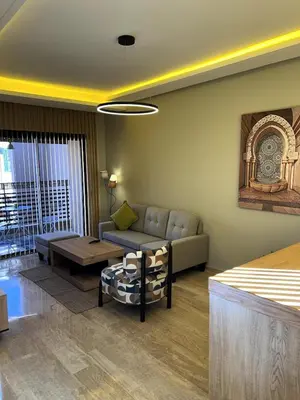 a living room with a couch and a table at Central Marrakesh Apartment in Marrakech