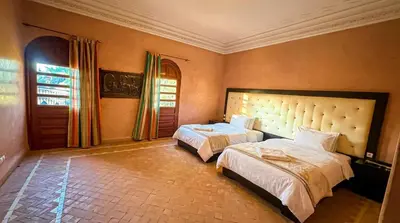 a large bedroom with two beds and a window at Charming Luxury Villa - Pool & Hot Tub in Marrakech
