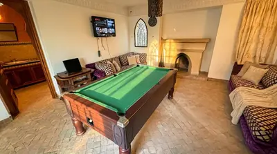 a living room with a pool table and a fireplace at Charming Luxury Villa - Pool & Hot Tub in Marrakech