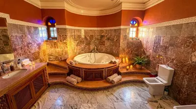 a large bathroom with a tub and a toilet at Charming Luxury Villa - Pool & Hot Tub in Marrakech