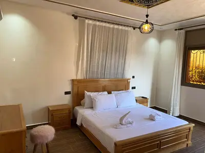 a bedroom with a bed with two towels on it at villa soufia in Marrakech