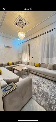 a living room with couches and a chandelier at villa soufia in Marrakech