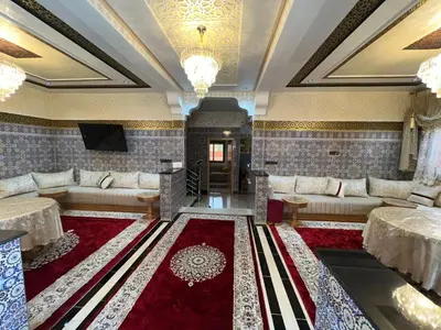 a living room with couches and a red rug at villa soufia in Marrakech
