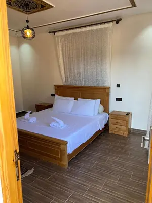 a bedroom with a bed with white sheets and a window at villa soufia in Marrakech