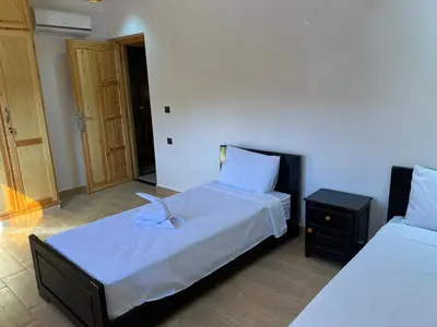 a bedroom with two beds and a night stand at villa soufia in Marrakech