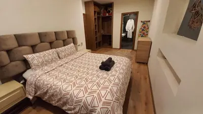 a black teddy bear sitting on a bed in a bedroom at Appartement proche Gueliz in Marrakech