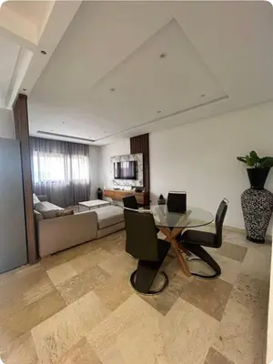 a living room with a table and a couch at Appartement proche Gueliz in Marrakech