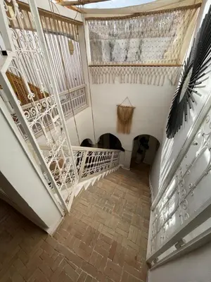 a staircase in a house with a ceiling at Riad El Charsa, logement entier 4 à 6 personnes, proche Jemaa El Fna, Rooftop et bassin chauffé in Marrakech
