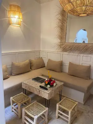 a living room with a couch and a table at Riad El Charsa, logement entier 4 à 6 personnes, proche Jemaa El Fna, Rooftop et bassin chauffé in Marrakech