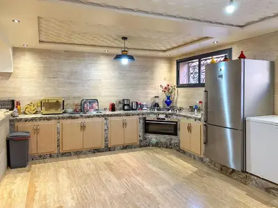 a kitchen with a stainless steel refrigerator at Villa Caprice Palace in city center in Marrakech