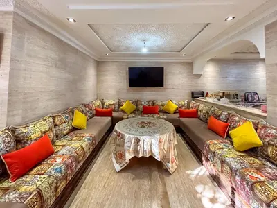 a living room with a couch and a table at Villa Caprice Palace in city center in Marrakech
