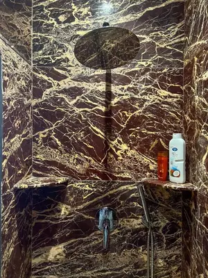 a bathroom with a marble wall with a sink at Villa Caprice Palace in city center in Marrakech