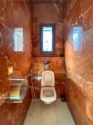 a small bathroom with a toilet and a window at Villa Caprice Palace in city center in Marrakech