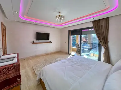 a bedroom with a bed and a tv on the ceiling at Villa Caprice Palace in city center in Marrakech