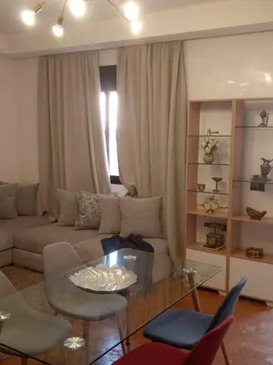 a living room with a couch and a glass table at Appartement moderne à 5piscines in Marrakech