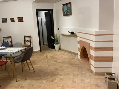 a living room with a table and a fireplace at Appartement moderne à 5piscines in Marrakech