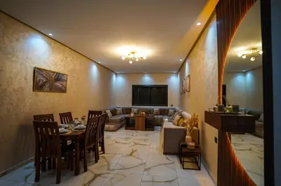 a living room with a table and a couch at New and luxurious apartment with a pool in Marrakech