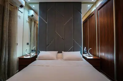 a bedroom with a large white bed with wooden panels at New and luxurious apartment with a pool in Marrakech