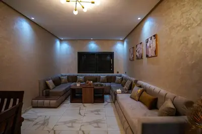 a living room with a couch and a table at New and luxurious apartment with a pool in Marrakech