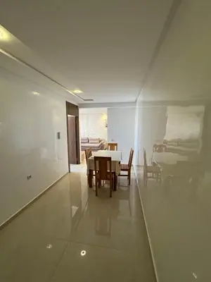 a dining room with a table and chairs at Burj Malak appartement pour les familles in Marrakech