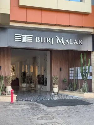 a store front of a building with a red fire hydrant at Burj Malak appartement pour les familles in Marrakech
