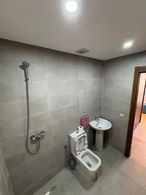 a bathroom with a toilet and a sink at Burj Malak appartement pour les familles in Marrakech