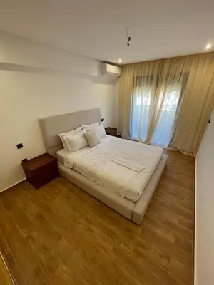 a bedroom with a large bed and a window at Palmeraie Appart B4 Piscine & Parking in Marrakech