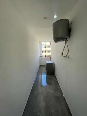 a hallway with a room with a television on the wall at Palmeraie Appart B4 Piscine & Parking in Marrakech