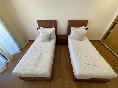 two beds sitting next to each other in a room at Palmeraie Appart B4 Piscine & Parking in Marrakech