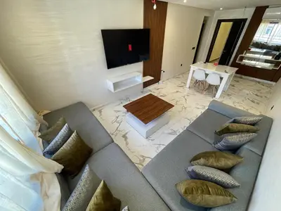 a living room with two couches and a tv at Luxury 2BR Pool Apartement Marrakech in Marrakech