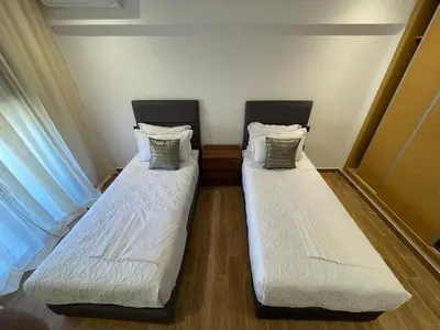 two beds sitting next to each other in a room at Luxury 2BR Pool Apartement Marrakech in Marrakech