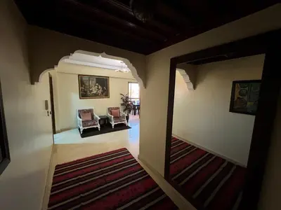 a hallway with a mirror and a living room at Appartement près de la gare de Marrakech in Marrakech
