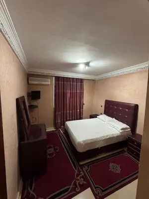 a hotel room with a bed and a chair at Appartement près de la gare de Marrakech in Marrakech