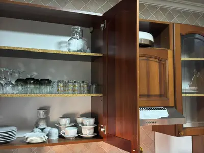 a cabinet filled with plates and cups and bowls at Appartement près de la gare de Marrakech in Marrakech