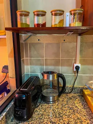 a kitchen counter with a coffee pot and a toaster at Stunning Patios & Gardens Apartment in Marrakech