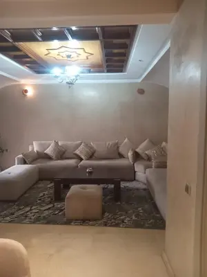 a living room with a couch and a table at Résidence SOFIA PALMERAIE in Marrakech