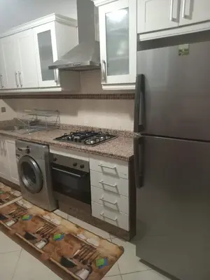 a kitchen with a stove and a refrigerator at Résidence SOFIA PALMERAIE in Marrakech
