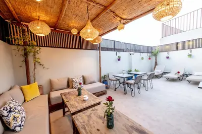 a living room with a couch and tables and chairs at Riad Dar Yousra in Marrakech
