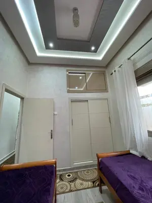 a bedroom with a bed and a ceiling with a door at Mima in Marrakech