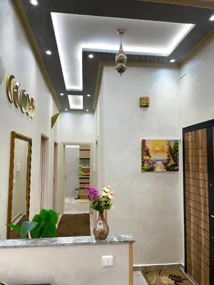 a lobby with a vase of flowers on a counter at Mima in Marrakech