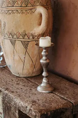 a vase sitting on top of a table with a candle at Hotel & Spa La Ferme El Dar in Marrakech