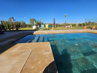 a large swimming pool with clear blue water at Maison de vacances avec piscine in Marrakech