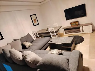 a living room with a couch and a table at Studio Central Nour in Marrakech