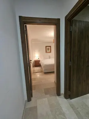 a hallway with a bedroom with a bed in a room at Studio Central Nour in Marrakech