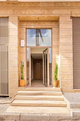 an entrance to a building with two potted plants at Le COSY CHIC- NEUF - Modern & Chic - Terrasse et Confort - CLIM PARKING et WIFI Gratuit ! GUELIZ in Marrakech