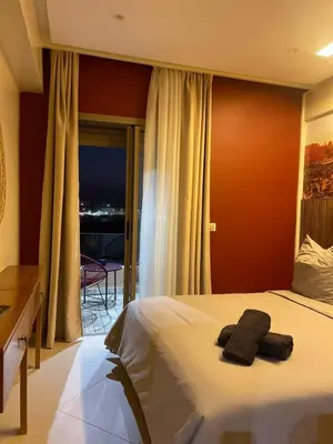 a hotel room with a bed with two towels on it at New ! LE CHOUKECH - Proche GARE - WIFI Inclus - CLIM et BALCON- GUELIZ by LoubnaConciergerie in Marrakech