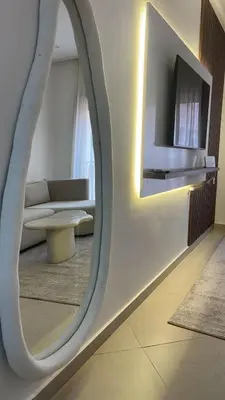 a living room with a mirror and a couch at Logement F2 neuf Gueliz Gare in Marrakech