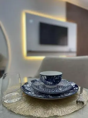 a plate with a cup and a glass on a table at Logement F2 neuf Gueliz Gare in Marrakech