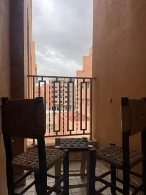 two chairs and a table on a balcony at Logement F2 neuf Gueliz Gare in Marrakech