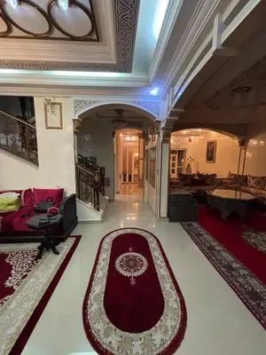 a living room with a couch and a red rug at Villa Saber in Marrakech